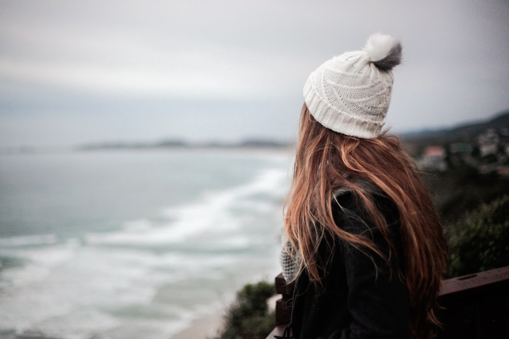 woman facing body of water