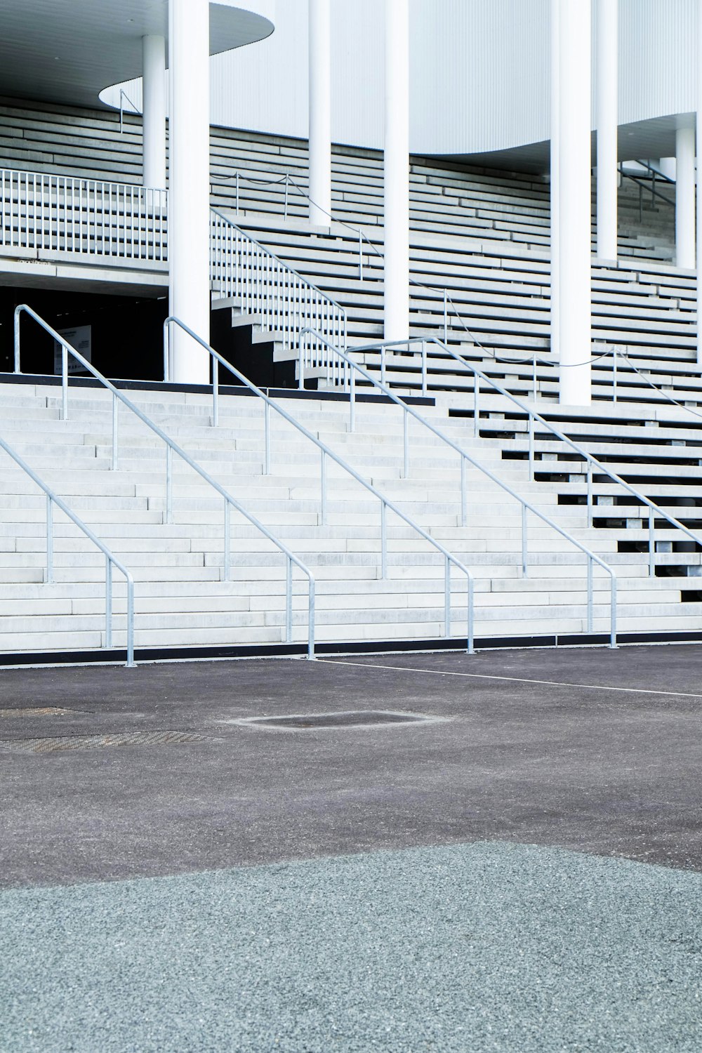 white stairs with metal railings in front of building