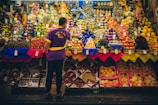 man standing in front of produce stand