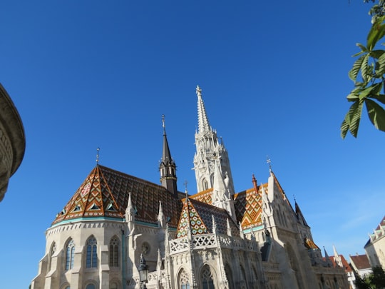 white and brown concrete building under blue sky at daytime in Fisherman's Bastion Hungary