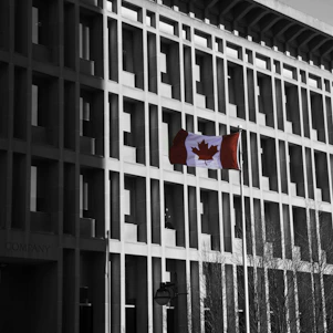A welcoming office space in Montreal with Canadian flags and legal books symbolizing immigration consultancy.