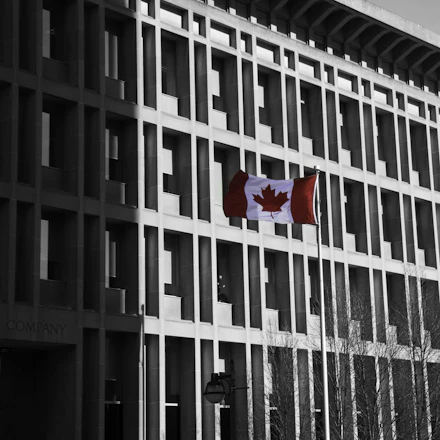 A sleek, modern office space with Canadian flags subtly displayed, reflecting professionalism and trust.