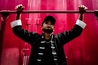 boy both hand hanging on metal bar