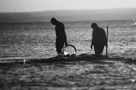 grayscale photography of men walking near shore in Tekirdağ Turkey