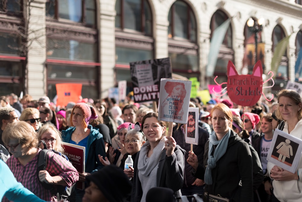 people holding flyers during daytime