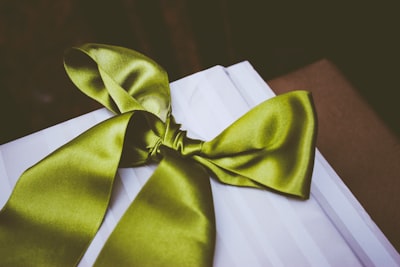 green bow tie on table trimming teams background