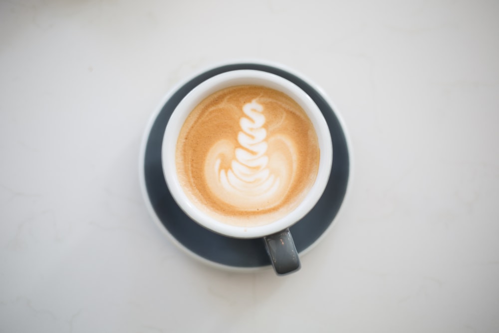 gray and white ceramic cup with coffee latte art