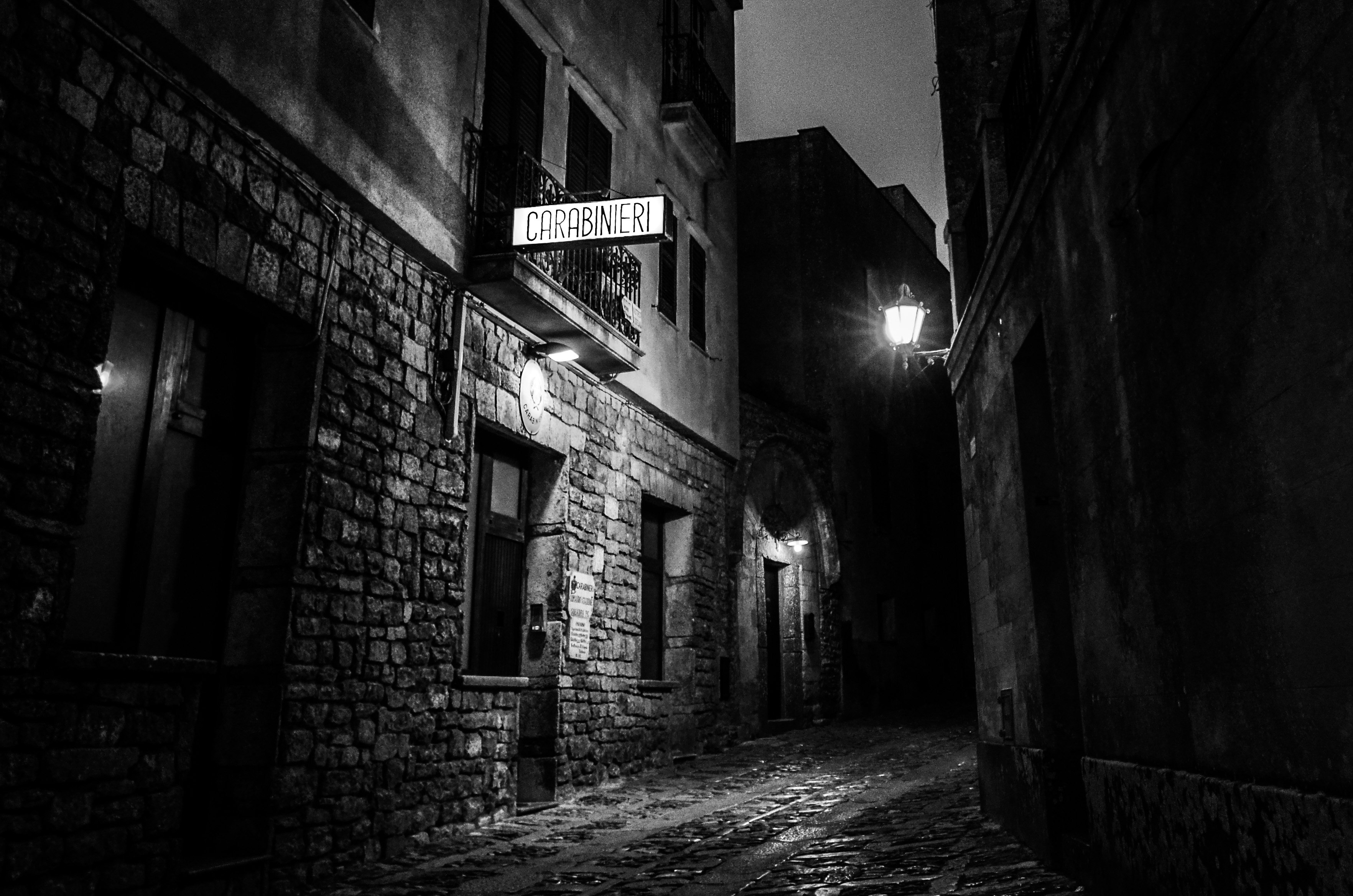 city alleyway with Carabineri signage during nighttime