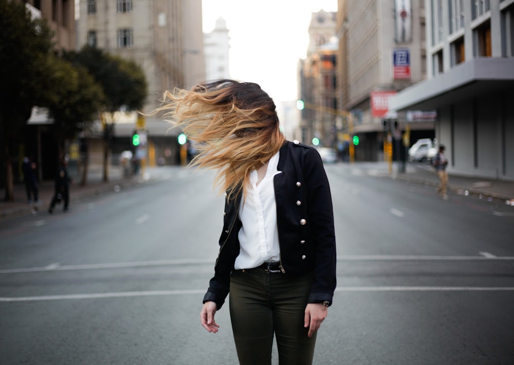 woman waving hair by the wind on road