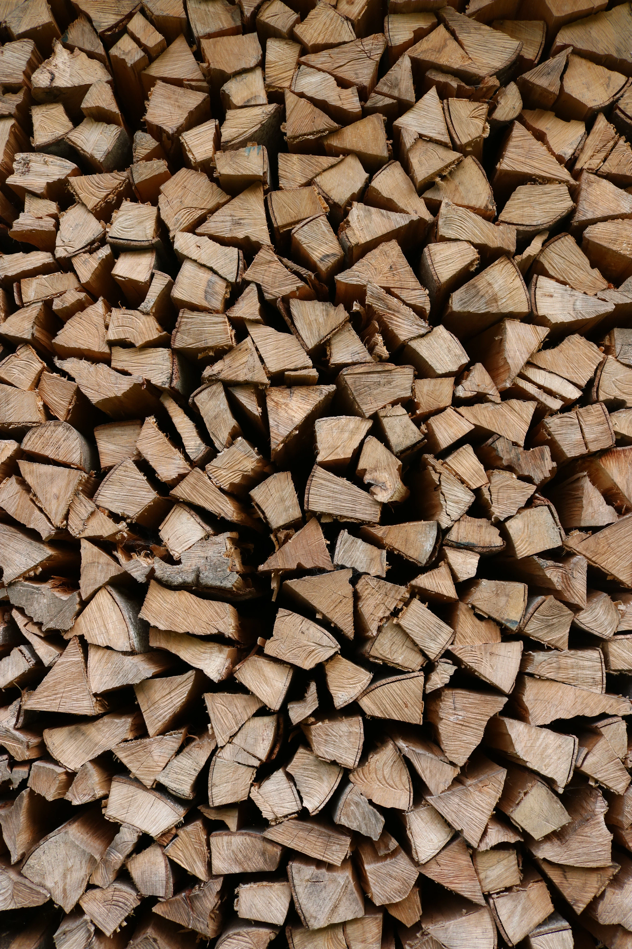 A textured stack of split firewood logs