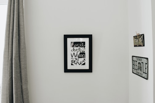 A minimalist artist's studio corner with brushes and vibrant fileteado paintings on the wall