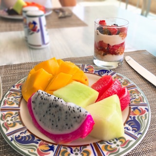 A cheerful breakfast spread with homemade granola, yogurt, and sliced seasonal fruits.