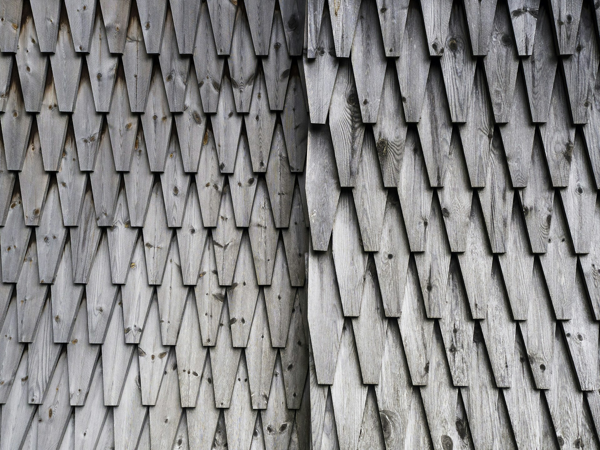 a close up of a building with a wooden roof