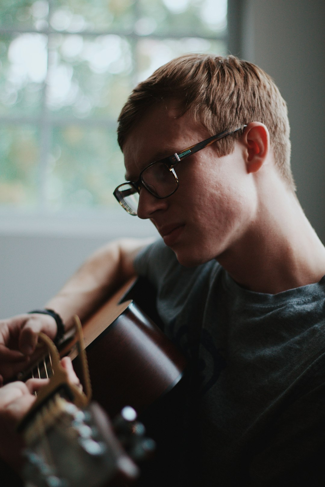 man playing acoustic guitar