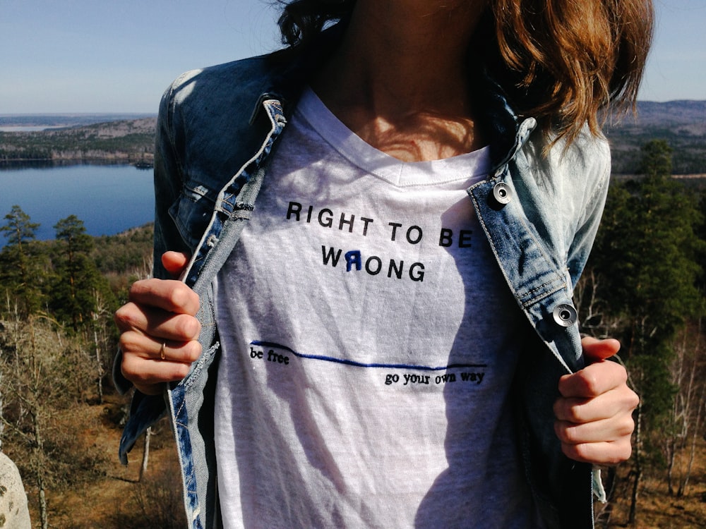 woman holding denim jacket