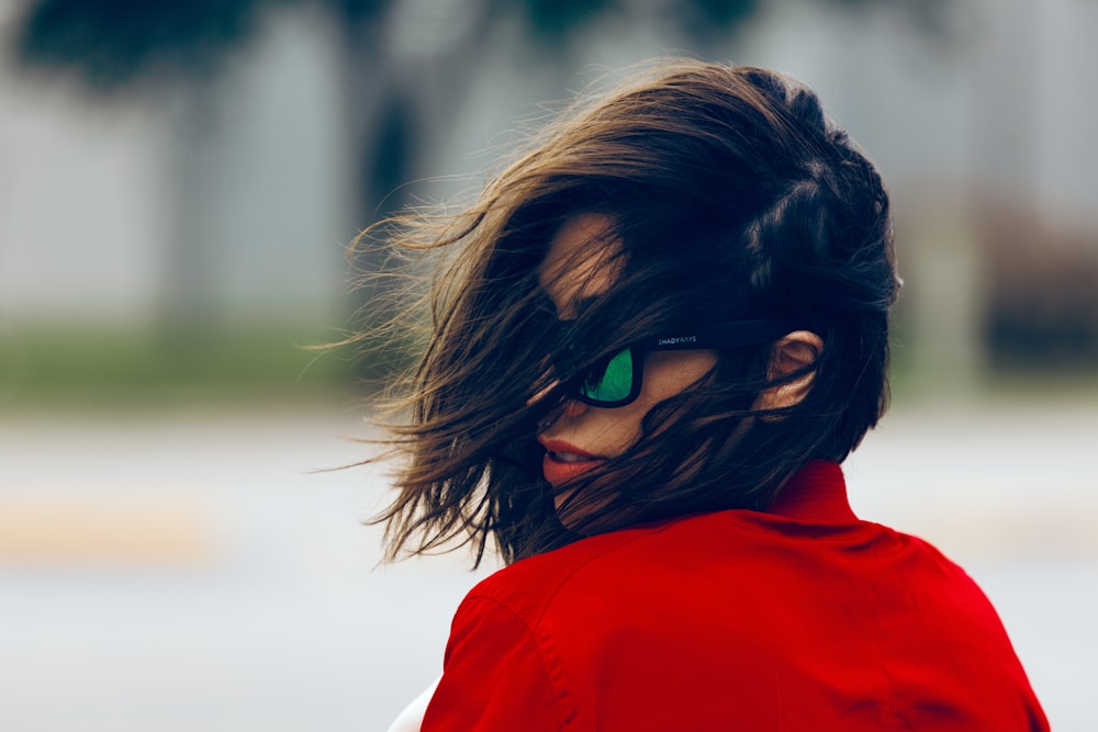 woman wearing red top and black sunglasses at daytime