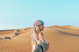 man and woman holding hands while in desert