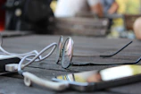 Side view of lightweight smart glasses resting on a minimalist wooden table.
