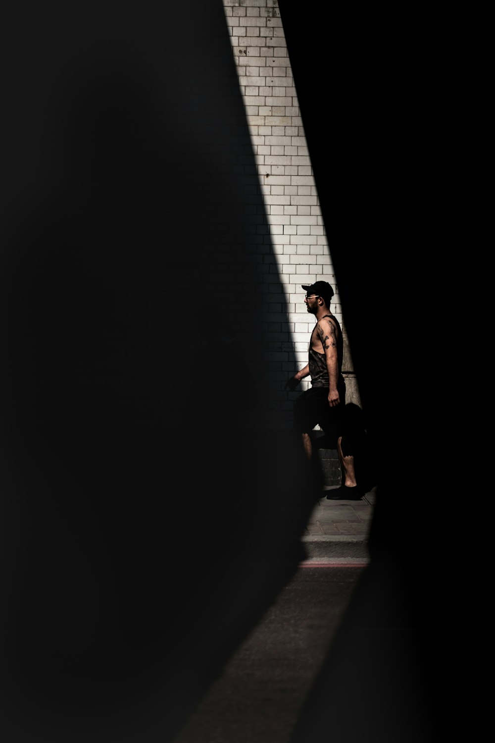 man walking at the brick pavement