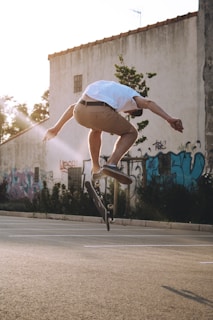 A dynamic shot of a skateboarder mid-trick wearing Urbanpiso apparel, with city buildings blurred in the background.