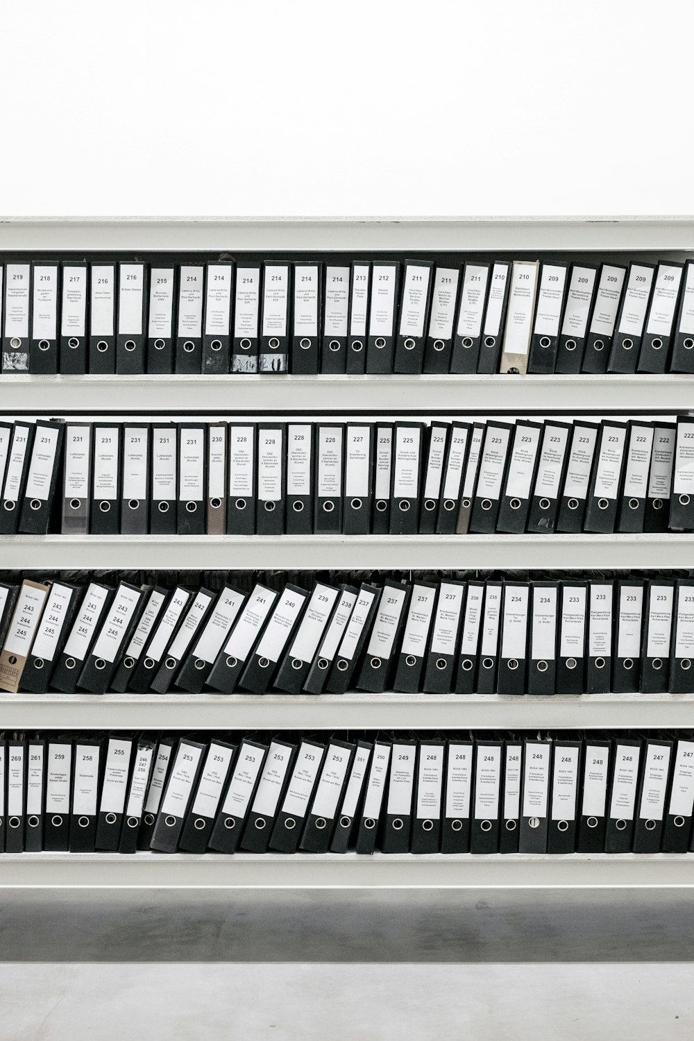 black binders on steel rack