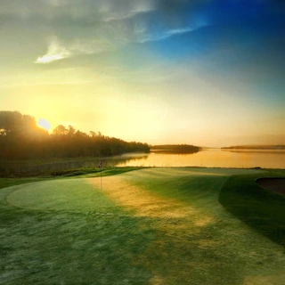 Sunset view over a quiet golf course with flags waving gently in the breeze