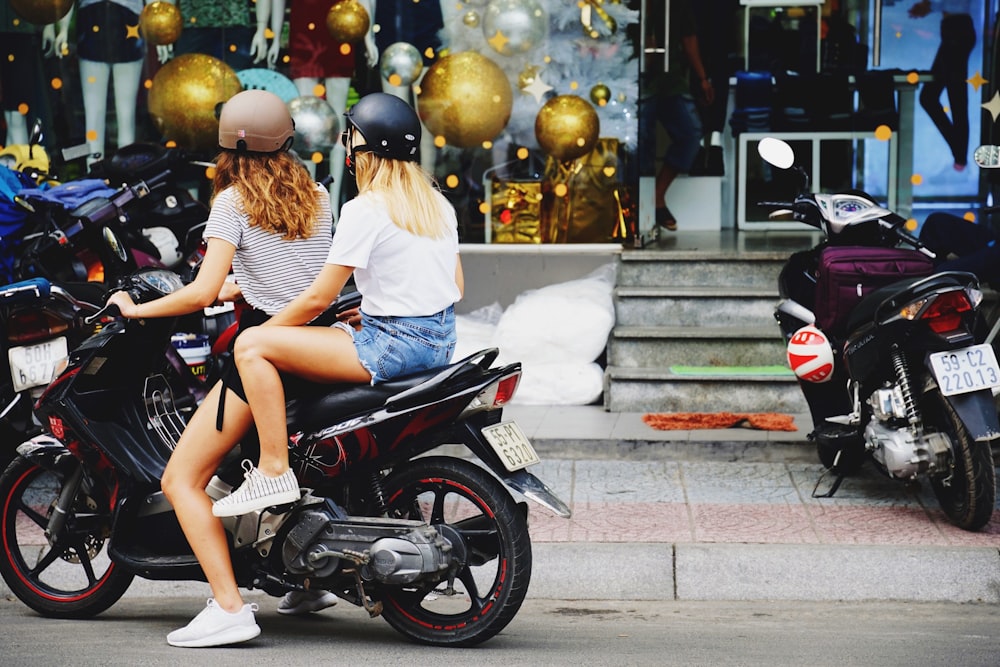 two women riding motorcycle