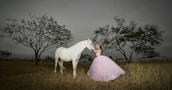 girl holding white horse head