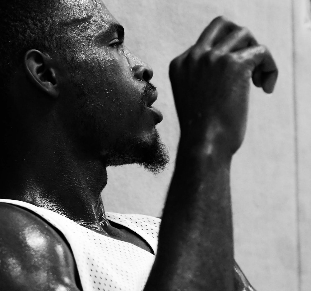 grayscale photo of man in tank top