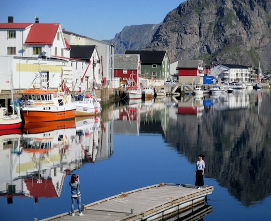 woman standing on corner of dock in Henningsvær Norway