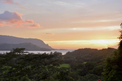 A scenic view of Santa Catarina’s lush green mountains and coastline at sunset.