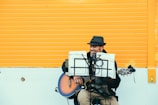 man playing brown and black acoustic guitar