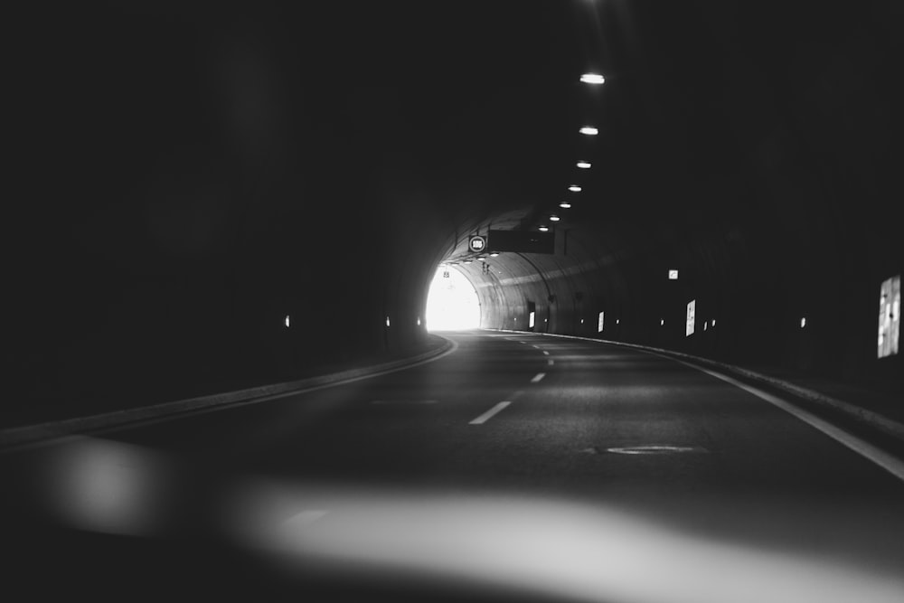 grayscale photography of a tunnel