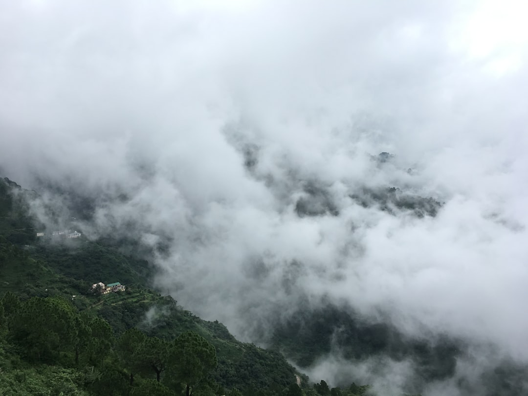 white clouds over a mountain
