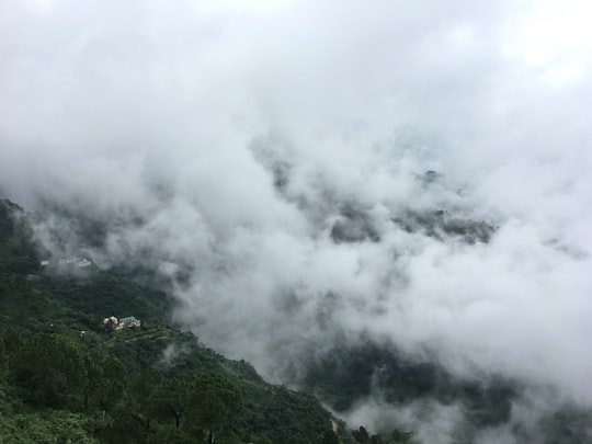 white clouds over a mountain in Kasauli India