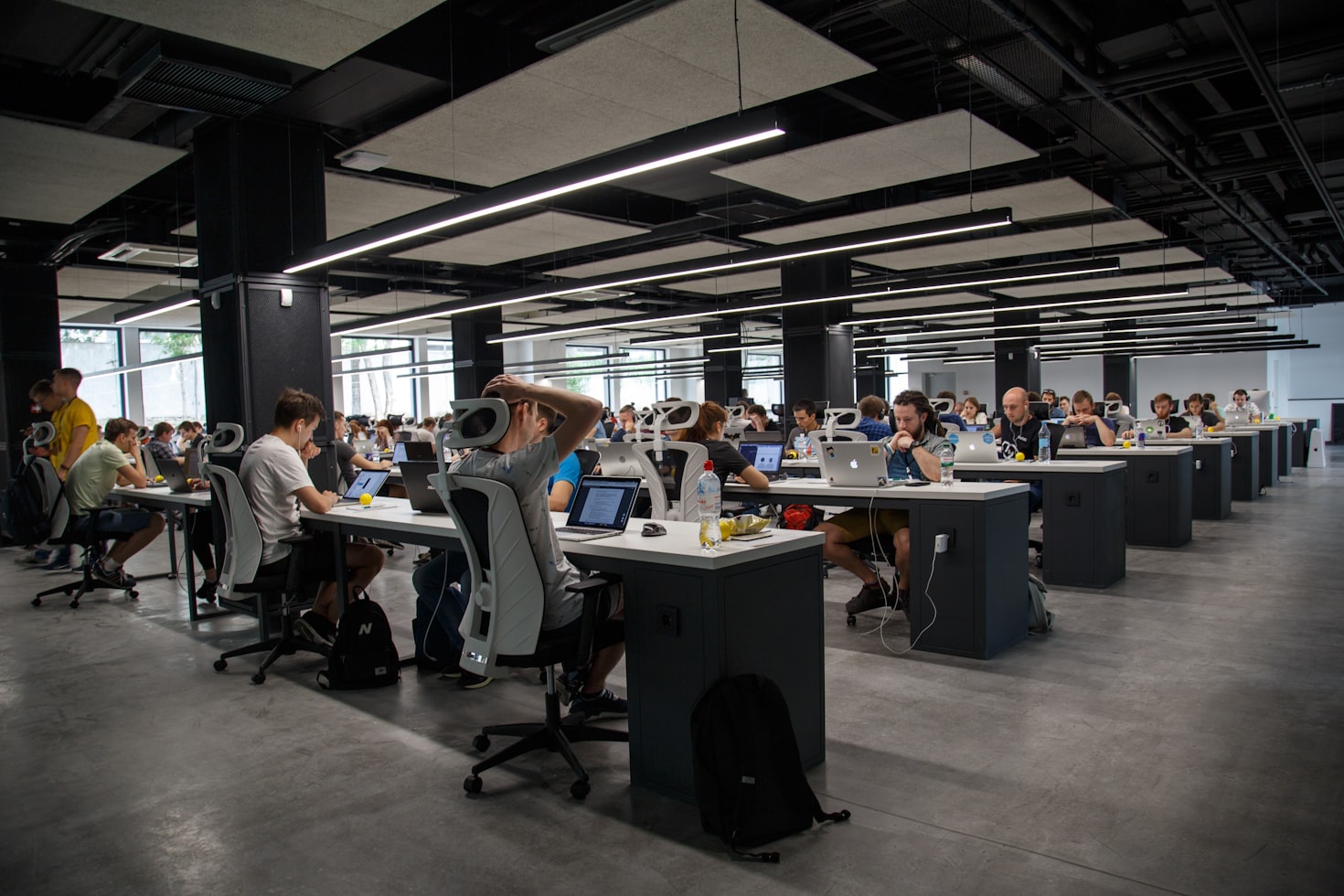 Several people working in an open office floor plan. 