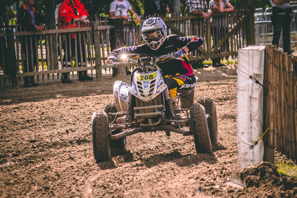 person riding ATV on mud road