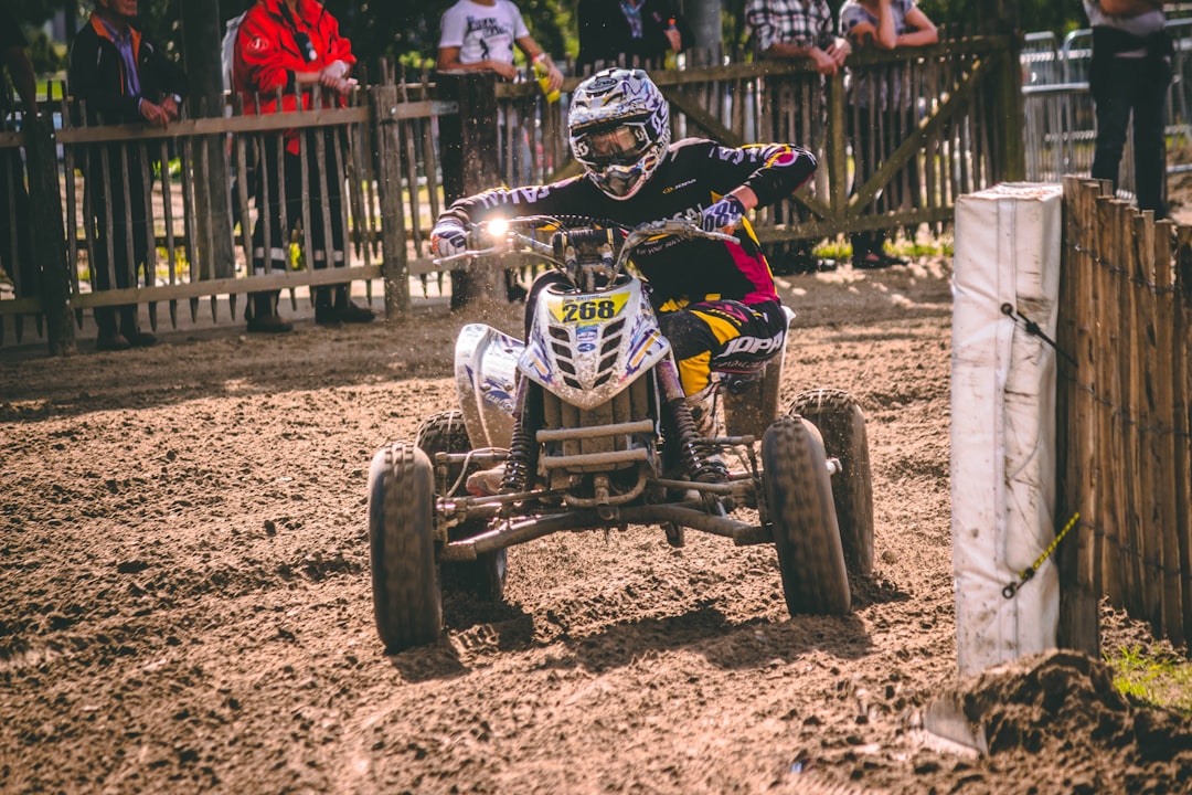 person riding ATV on mud road,