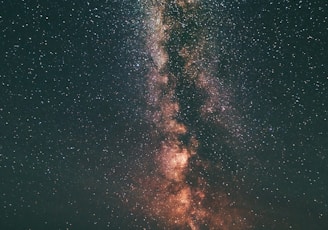 three person looking stars and milky way