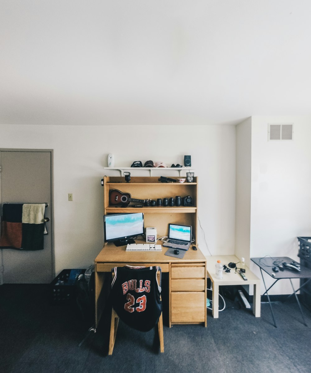 brown wooden desk with computer set