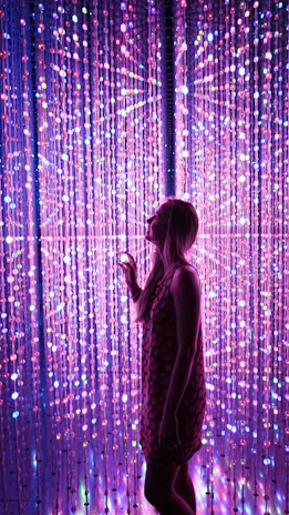A vibrant LED curtain glowing in front of a storefront at night, attracting attention from passersby.