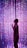 A woman stands in front of a dazzling array of LED lights that create a vibrant and immersive atmosphere. The lights form a curtain of pink, purple, and blue hues, with some bulbs varying in brightness to add depth and interest.