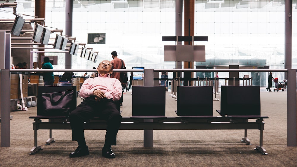 person sleeping on gang chair