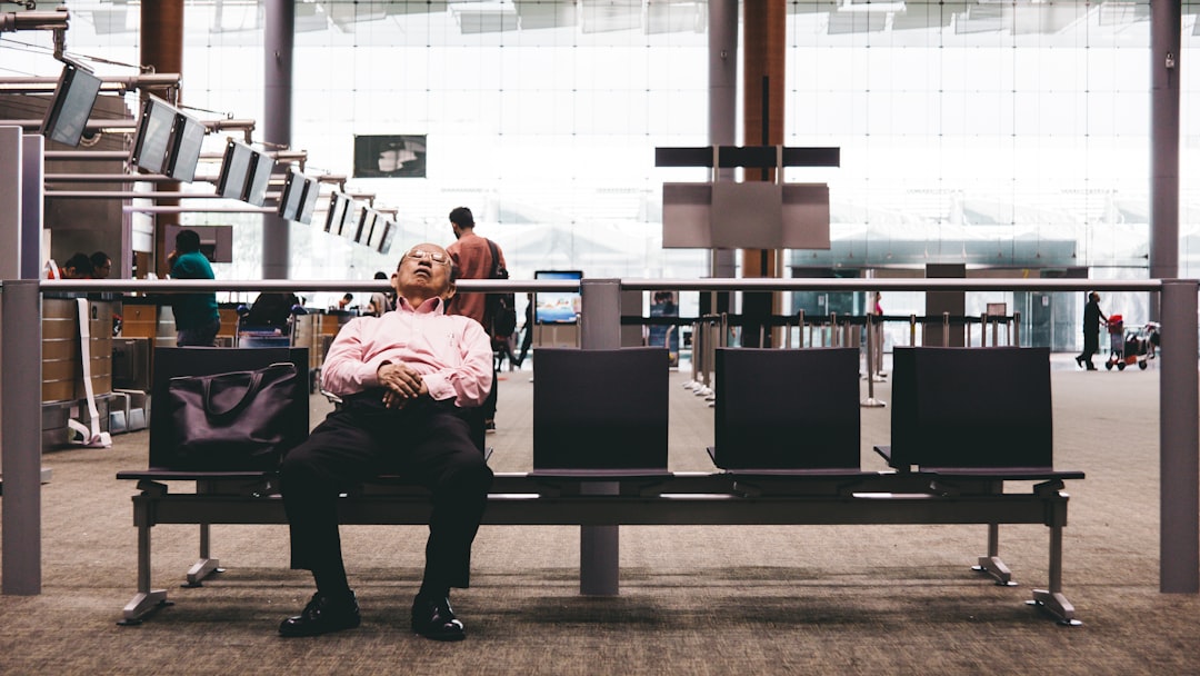 person sleeping on gang chair, Tired Of Waiting…
