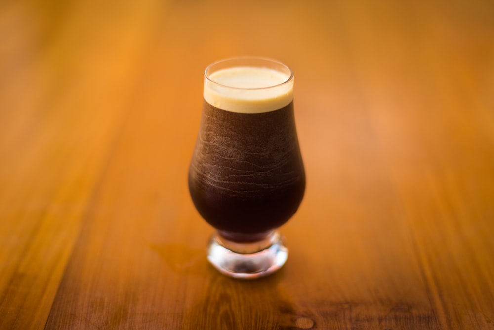 closeup photo of footed tea glass filled with tea