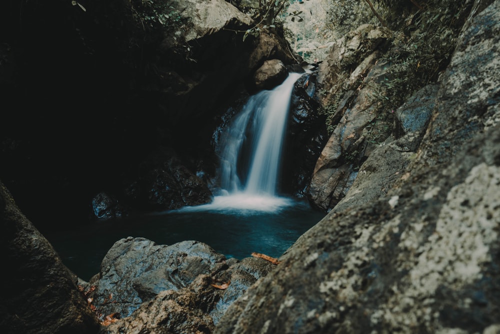 waterfalls near rock mountain