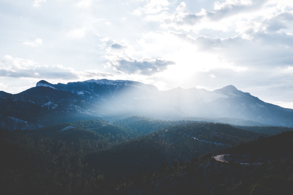 silhouette of mountain under cloudy sky during daytime