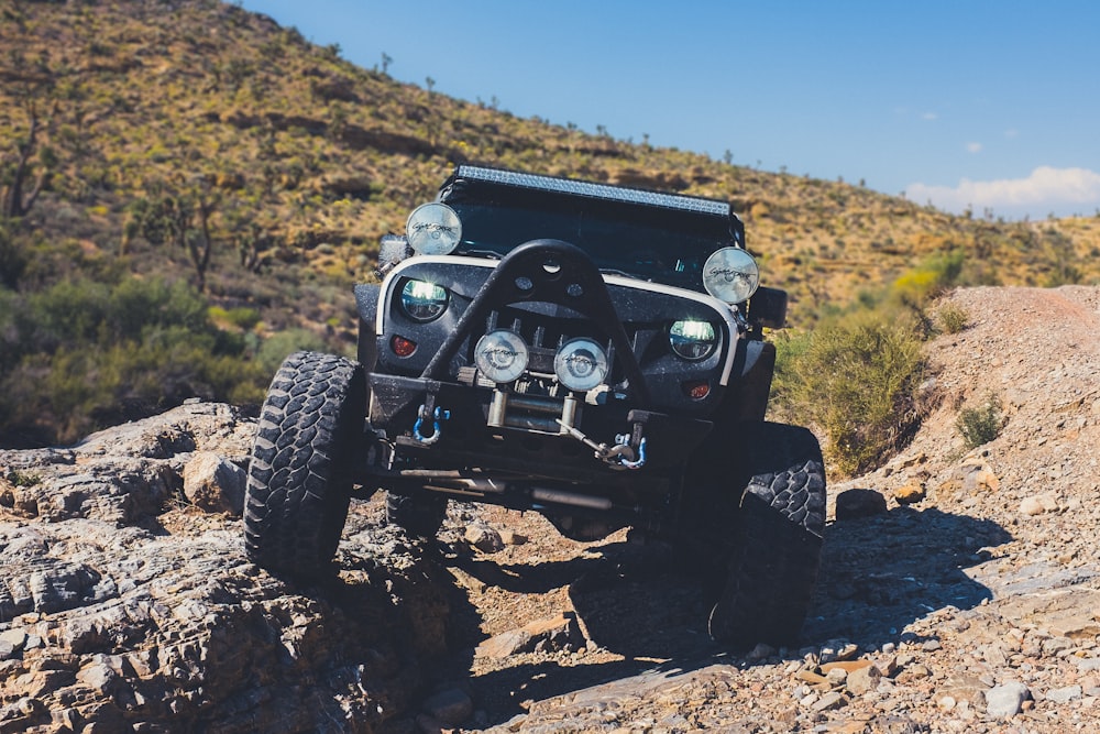 black Jeep Wrangler on land during daytime