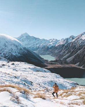 person standing on snow covered mountain in mount cook national park on our adventure tour