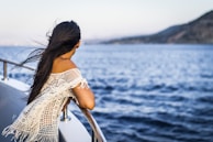 woman on the boat watching the sea